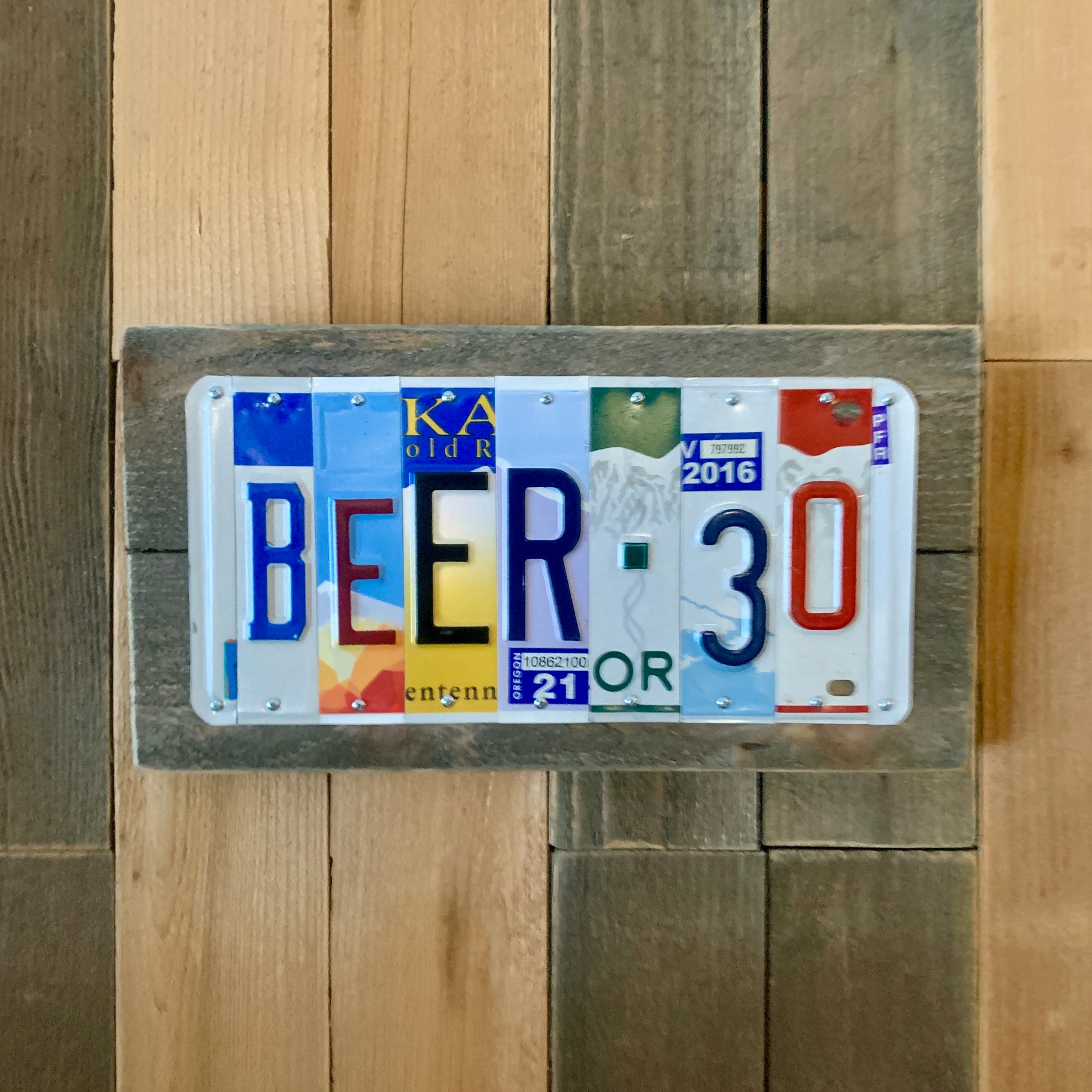 beer 30 license plate bar sign, US license plates are cut into individual pieces to make custom wedding date, tenth anniversary traditional aluminum gift,   An artful eye paired with quality craftsmanship!  Colorful license plates!  We have developed relationships with many sources and are continually buying plates that are in good condition, have great color, and plenty of graphical interest.  We incorporate both embossed and flat style license plates which allows us to accommodate custom state request for