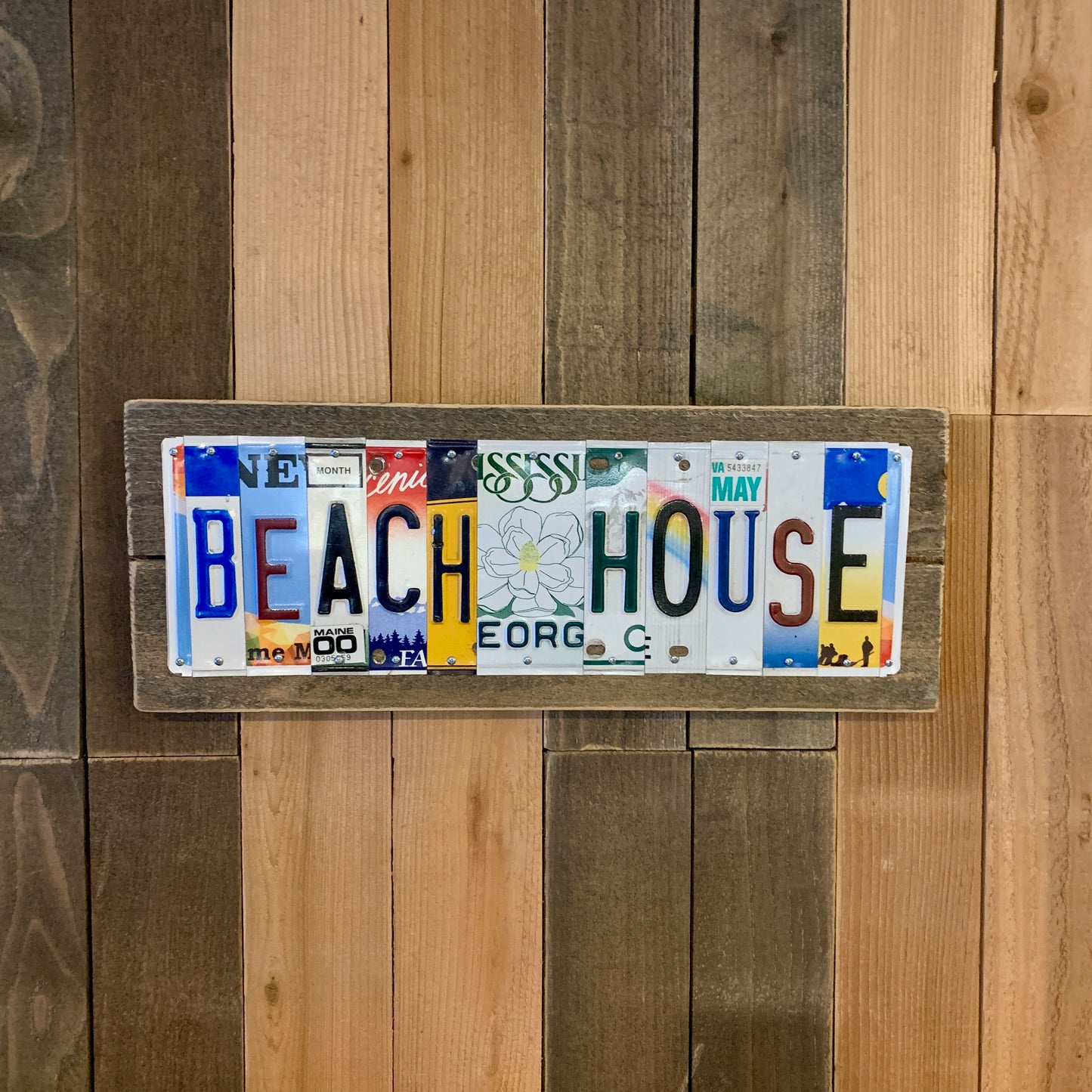 beach house sign created by US license plates are cut into individual pieces to make custom wedding date, tenth anniversary traditional aluminum gift