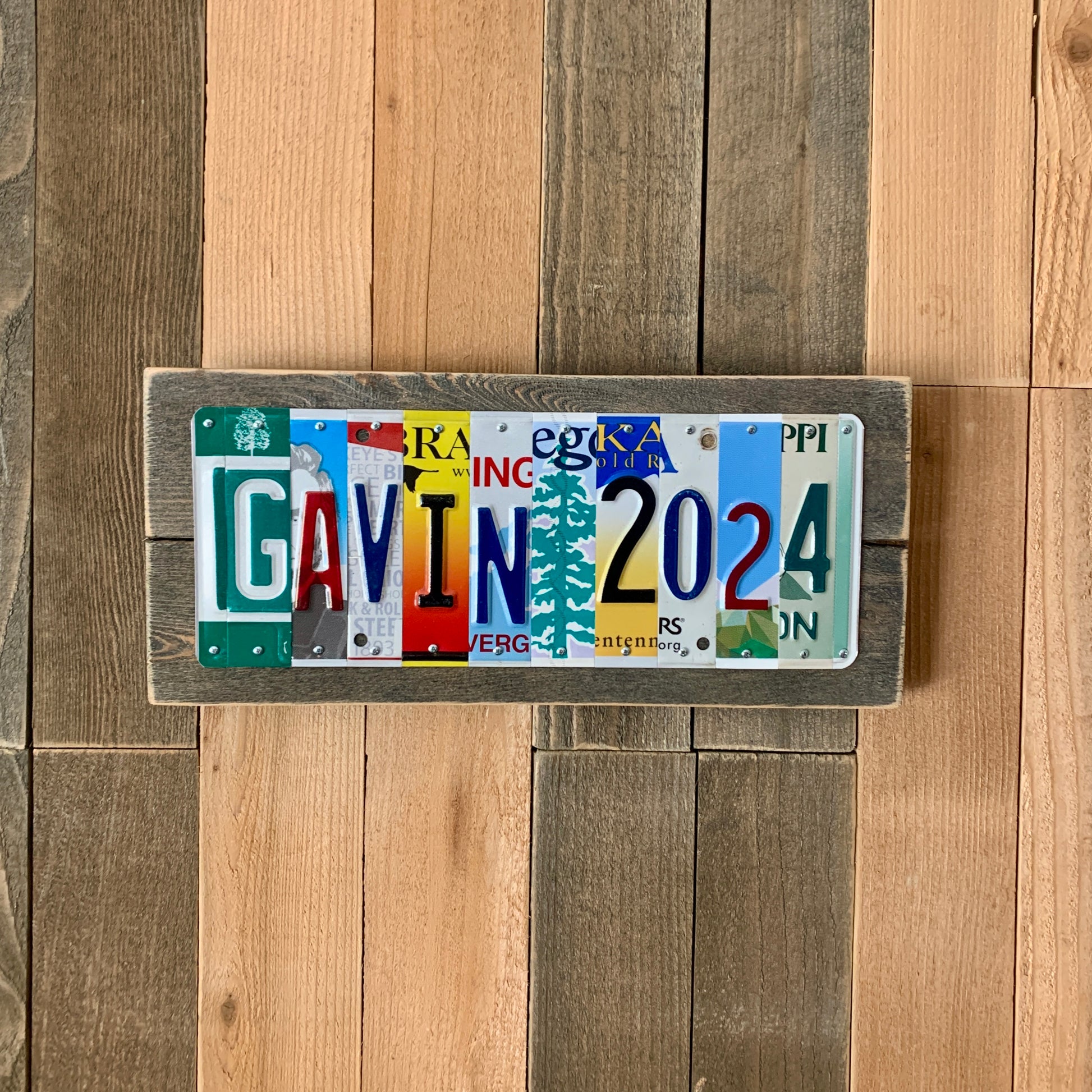 license plate sign made by cutting license plates into individual letter and number pieces to form graduate's name and graduation year.