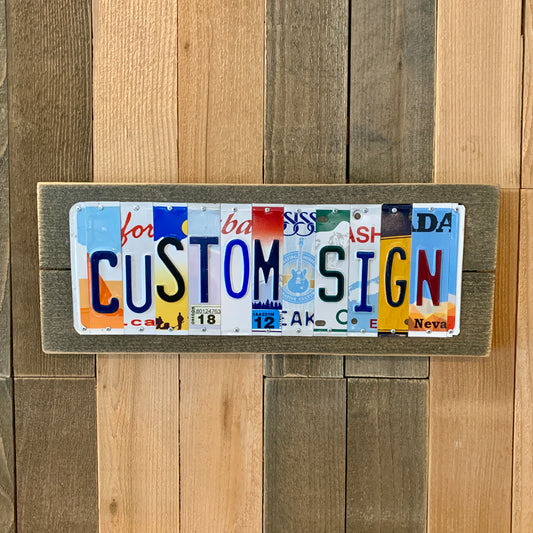 custom license plate sign made by cutting license plates into individual pieces to spell names