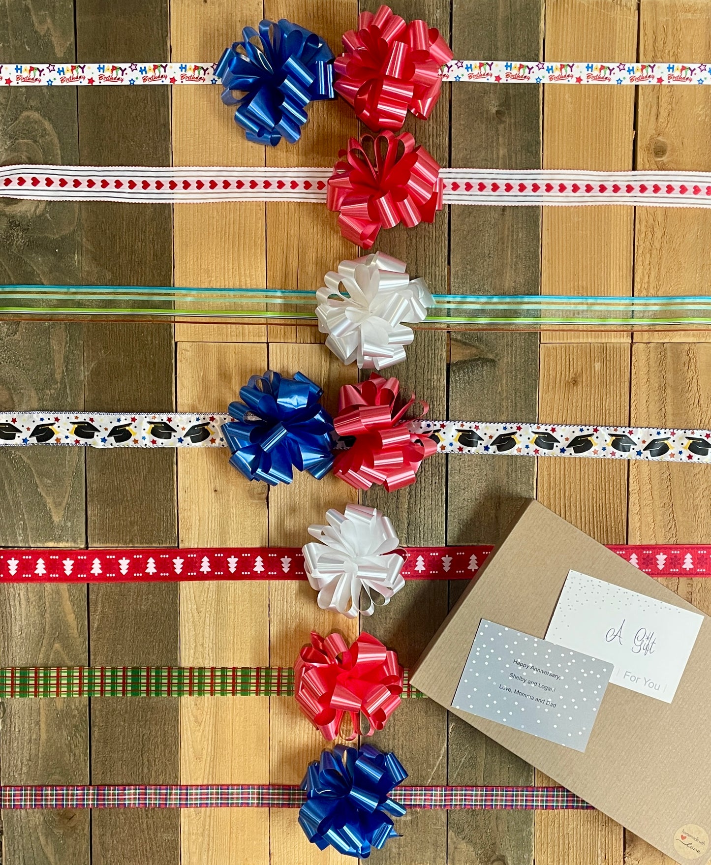 gift wrap options include happy birthday ribbon with blue or red bow, red heart ribbon with red bow, multi color strip with white bow, graduation ribbon with blue or red bow, christmas tree ribbon with white bow, green and red plaid ribbon with red bow, red and blue plaid ribbon with blue bow, kraft color box with made with love sticker.