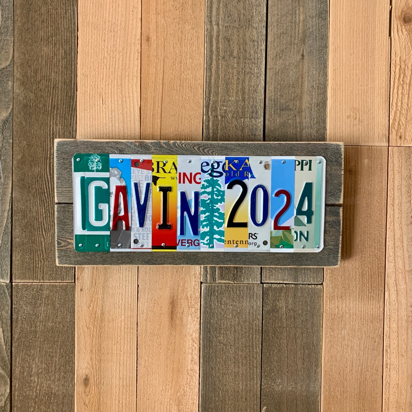 license plate sign made by cutting license plates into individual letter and number pieces to form graduate's name and graduation year.