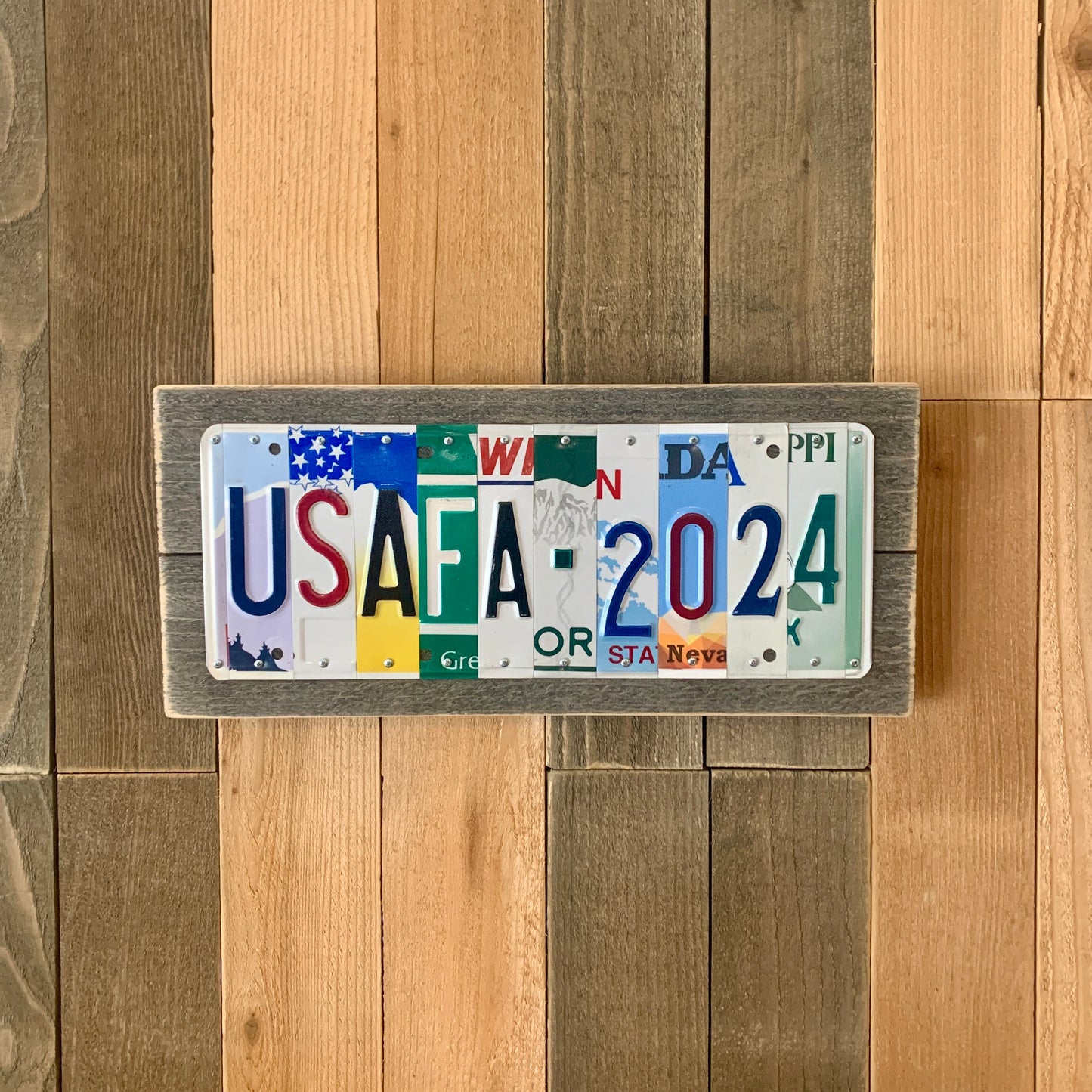 license plate sign made by cutting license plates into individual letter and number pieces to form graduate's name and graduation year.