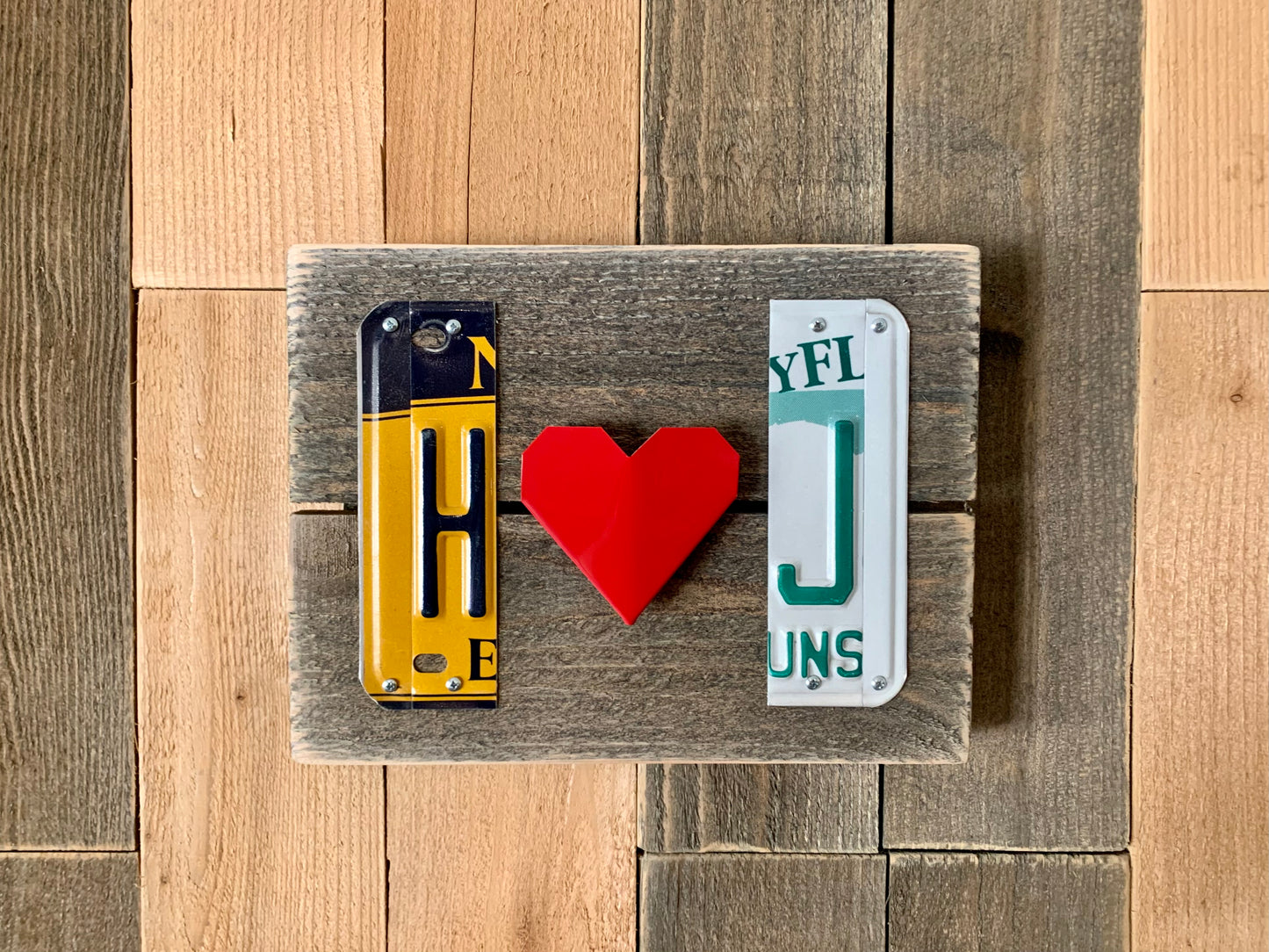 handmade genuine license plate initials with folded red heart in the center